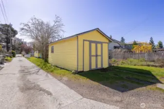 The garage has doors that open and is used as a storage area. There is a large garden space to the west of the garage.