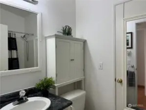 Pass through hall/guest bathroom, which leads to the utility/laundry room.