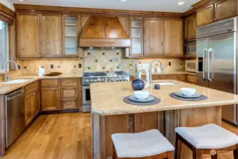 Custom cabs, tile work, and granite! This high end, Chef's kitchen includes professional grade SS appliance package and is an entertainers delight!  Off the kitchen, step out to the covered patio for more entertaining fun!