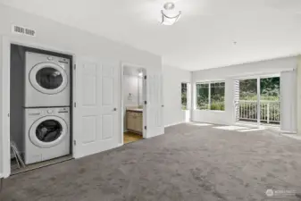 Full size washer and dryer and view of half bath