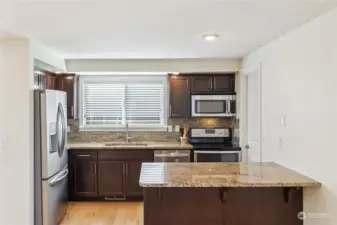 Great efficient kitchen features stainless appliances and granite counters.  New blinds!