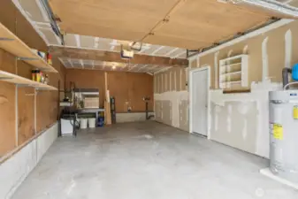 Attached 1-car garage with utility space along back wall