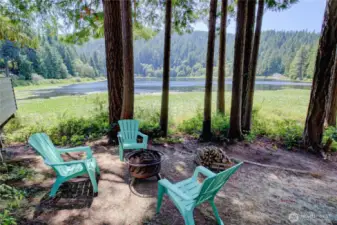 Sitting area with fire pit located below the unit on the shores of the Lake.