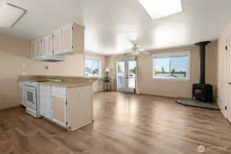 As you enter the home, kitchen is on the left and living area with French doors to back deck. Skylight adds to the bright and airy feel of this home.