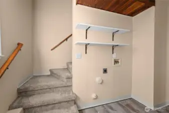 Stairs from upper level into the laundry area.