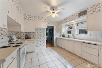 Either embrace the wallpaper and fully functional kitchen, or bring your own vision to modernize this great space.