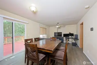 Dining room with laminate flooring and slider to the back deck.