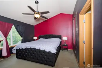 Primary bedroom on the upper floor with vaulted ceilings, walk-in closet, ensuite bath, AND additional adjacent small room for some more space and/or storage.