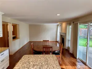 View of the family room from the kitchen island.  Large slider that goes to the backyard covered patio.