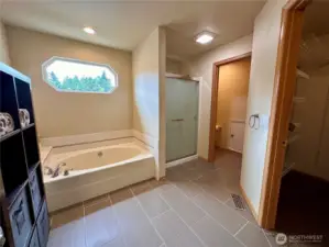 Master Bathroom with double sinks, large tub, separate shower, walk-in closet, and private toilet room.