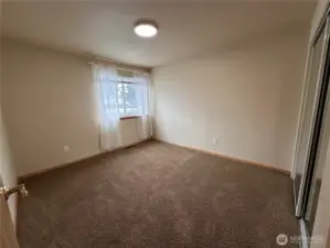 Secondary bedroom on the front side of the home with a large closet with mirrored doors to help you get ready in the morning.