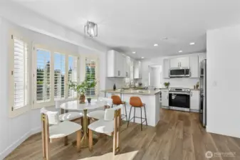 Light-filled kitchen & eating area with quartz counter tops & stainless steel appliances!