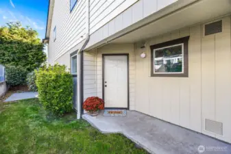 A charming front walkway leads to a covered patio entry framed by fresh paint and clean landscaping. This welcoming space captures the relaxed pace of coastal living in Oak Harbor.