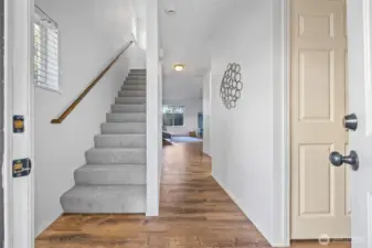 The inviting entry captures the relaxed pace of Whidbey Island living. New carpet (2025) and natural light guide you upstairs to private bedroom retreats.