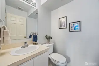Convenient main-floor powder bath with adjacent storage closet—ideal for guests and daily living.