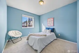 Large secondary bedroom with generous closet space, custom blinds, and fresh paint—ready for guests or a creative workspace.