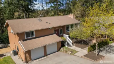 Aerial view showcasing the home’s peaceful setting surrounded by mature trees in desirable Central Sammamish.