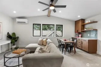 This entertainment space with a bar and kitchenette is perfect for hosting, offering a seamless flow between lounging, dining, and casual drinks. With stylish finishes, natural light, and a relaxed layout, it’s designed for both everyday comfort and lively gatherings.