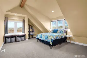 A flexible room with vaulted ceilings can be your bedroom, guest room, office, gym, or creative space. The window on the right faces the front of the home, and the dormer gives elevated space above your head.