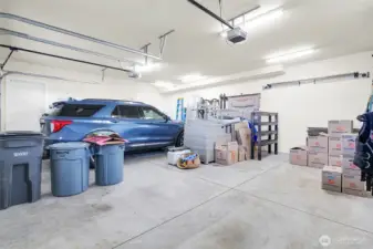 The home has a well-built, insulated two-car garage with storage, two hot water tanks, water softener, and space for shelving as well!