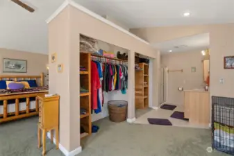 Primary suite with open concept bathroom, and custom cedar shelving for closet space.