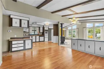 Another angle of the bright living space with kitchen and seating/living/dining area