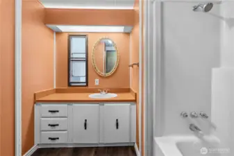 Bathroom off hallway has another large tub.