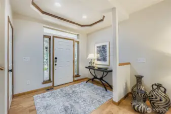 Spacious entry with tray ceiling and generous under-the-stairs coat and storage closet.