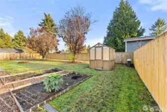 Established garden beds and cedar greenhouse