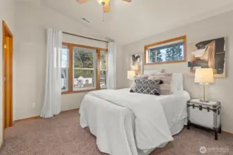 Light and bright primary bed with high ceilings.