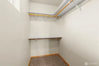 Closet featuring hanging storage and ample room for clothes and accessories.