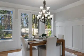 High ceilings, fresh paint and an abundance of natural light make this dining room a show stopper! The Wainscotting and French Doors are so beautiful.