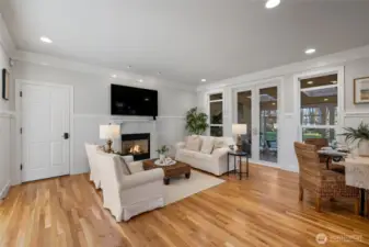 A view of the family room, and eating area to the right. Ahead notice the French doors leading out to the amazing sunroom.