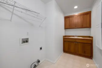 Laundry room conveniently located upstairs near bedrooms. Lovely storage cabinets for supplies.