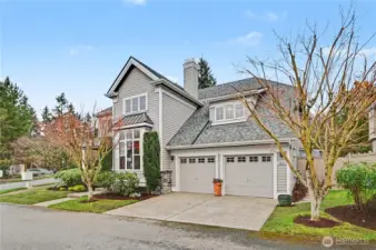 Striking curb appeal with sophisticated gray and white exterior accented by a vibrant red front door and two car garage.