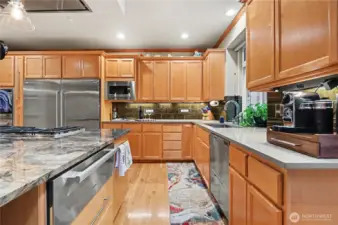 Abundant warm cabinetry and generous counter space provide both beauty and function.