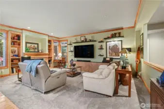 Inviting living room complete with gas fireplace, built-ins, and thoughtfully positioned windows.