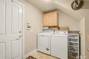 Downstairs laundry room with plenty of storage.