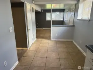 Lower level, unit B entry and eating space looking toward living room area.