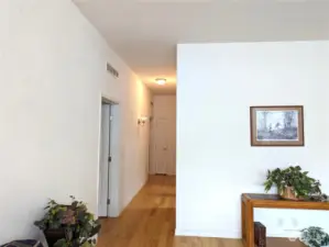 Hallway has 2 bedrooms at the end, with laundry room to the right.