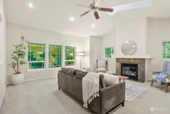 Spacious living room with vaulted ceilings, sky lights & gas FP.