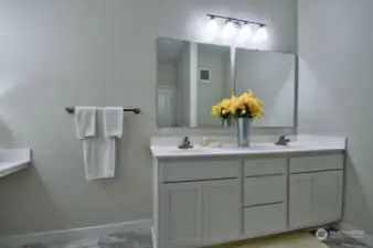 Primary bedroom suite has double sinks.