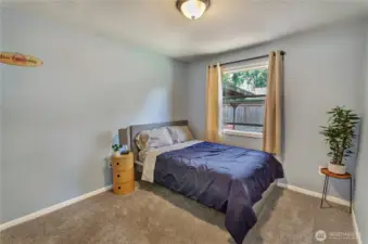 Cozy and inviting, this bedroom is the perfect retreat with soft carpet underfoot, fresh paint, and a large window that fills the space with natural light. Peaceful vibes included.