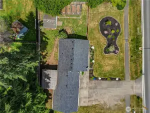 Bird’s-eye view of this beautifully maintained .25-acre lot! Fully fenced for privacy and security, with garden space, a shed, and room to roam—this outdoor setup is ready for play, pets, or planting.