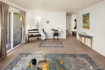 The great room features a wall of windows with a sliding door that opens onto the patio.