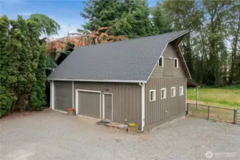 24x36 Shop with 10 Ft. high RV door along w/ additional garage door.  Shop has pellet stove & loft area.