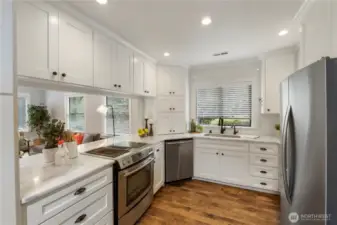Beautifully updated kitchen w/ Quartz counter tops, ample cabinet space &  SS appliances.