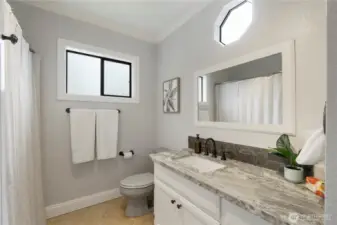 Upstairs' full bath with Quartz counters  & tiled floors.