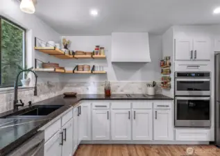 New countertops, sink, backsplash, shelving, and all stainless steel appliances.