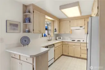 Kitchen with ample cabinet space & backyard views